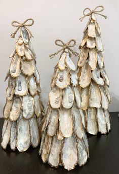 three seashell christmas trees are sitting on a table