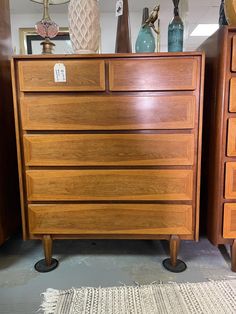 a wooden dresser sitting on top of a carpeted floor