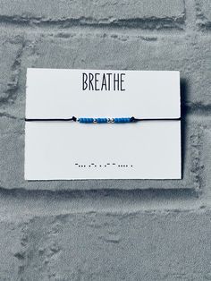 A super cute believe morse code bracelet! A black waxed cord bracelet with a sliding knot closure - so it would fit any sized wrist 😊 It has the word “Breathe” in morse code, which is made up from small 3mm light blue Toho beads and 3mm silver plated spacer beads. It comes on a small card as shown, and packaged inside a clear cello bag with a finishing of silver star confetti - making it the perfect gift 💛It looks lovely worn with any other bracelets, and completely eye catching! Please don’t Morse Code Bracelet Diy, Bracelet Morse Code, Bracelet Morse, Self Care Gifts, Wax Cord Bracelet, Star Confetti, Bracelets With Meaning