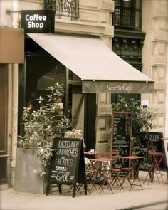 the outside of a coffee shop with tables and chairs