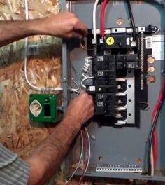 a man is working on an electrical panel