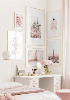 a white bedroom with pictures on the wall