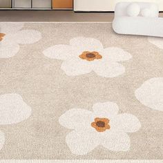 an area rug with flowers on it in a living room