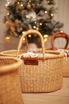 three wicker baskets sitting next to a christmas tree