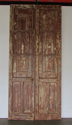 an old pair of wooden doors sitting next to each other