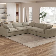 a living room with a large sectional couch in the center and a rug on the floor