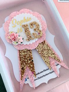 a pink and gold birthday card in a box