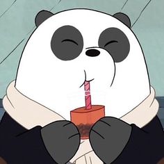 a panda bear holding a cup with a candle in it