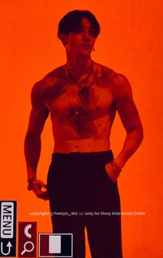 a man with no shirt standing in front of an orange background and holding his hands on his hips