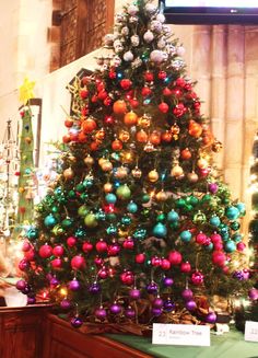 a brightly colored christmas tree is on display