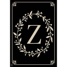 a black and white letter z with leaves on the border, in front of a gold frame