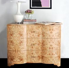 a wooden dresser with drawers and a lamp on top