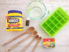 the ingredients to make an ice cream dessert are displayed on a white wooden table with spoons and plastic containers