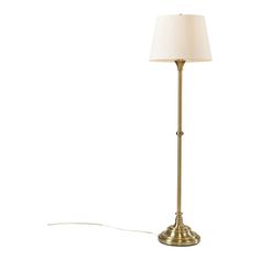 a floor lamp with a white shade on the base and a cord attached to it