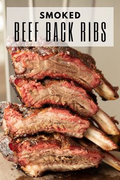 the ribs are piled on top of each other with text overlay that reads smoked beef back ribs