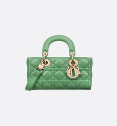 The Lady D-Joy bag captures the House's vision of elegance and beauty by showcasing the iconic streamlined aesthetic of the Lady Dior line. Crafted in jade green lambskin with Cannage stitching, the refined and timeless style is enhanced by pale gold-finish metal D.I.O.R. charms illuminating its silhouette. Featuring one detachable chain strap and another adjustable and removable leather strap, the small Lady D-Joy bag can be carried by hand, worn over the shoulder or crossbody as a daily compan Ethereal Green, Lady D Joy Bag, Lady D, Verde Jade, Womens Designer Bags, Dior Book Tote, Small Lady, Christian Dior Couture, Dior Couture