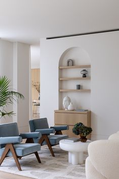 a living room filled with furniture and a potted plant