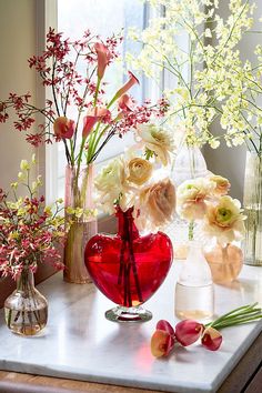 vases filled with flowers sit on a table