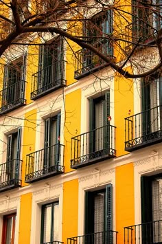 an apartment building with balconies and wrought iron railings