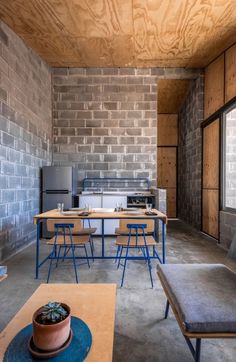 a living room filled with furniture next to a brick wall