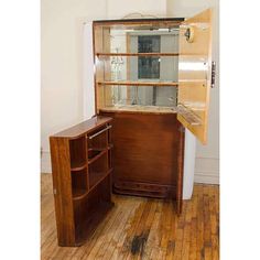 an old fashioned wooden cabinet with glass doors