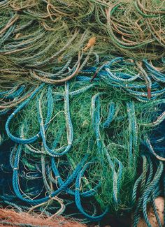 many blue and green ropes piled on top of each other