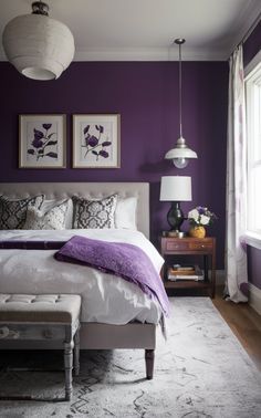 a bedroom with purple walls and white furniture