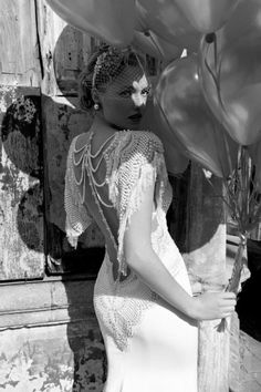 black and white photograph of a woman holding balloons