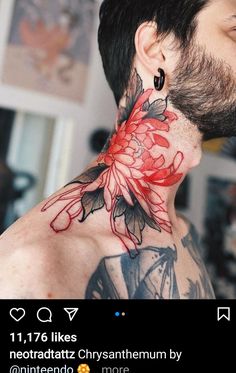 a man with tattoos on his neck has flowers painted on the back of his neck