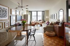 a living room filled with furniture and pictures on the wall next to a dining table