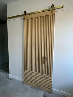 an open sliding door in a room with white walls