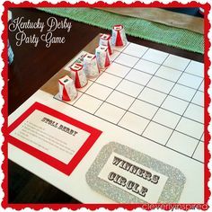 a monopoly board game with red and white paper cups on it, sitting on a table