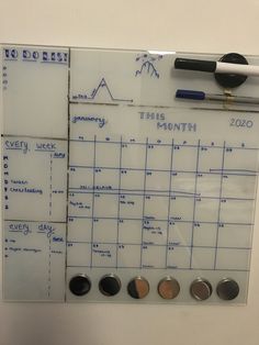 a white board with magnets and other things on it