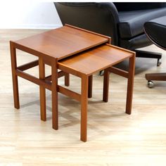 two wooden tables sitting next to each other on top of a hard wood floored floor