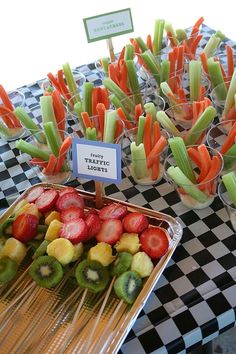 there are many fruits and veggies on display at the table with name tags