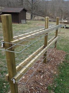 an instagramted photo of a wire fence with wood posts on the top and bottom