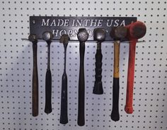 there are many different types of spoons hanging on the wall with words made in the usa hors d'oeuvres