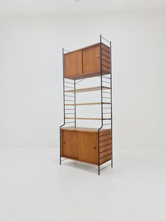 a wooden and metal shelving unit with two shelves on each side, against a white wall