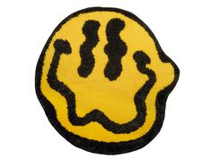 a yellow and black rug with an image of a hand drawn face on it's side