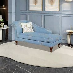 a blue couch sitting on top of a white rug