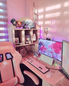 a pink computer chair sitting next to a desk with a monitor and keyboard on it