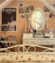 a bedroom with a bed, dresser and mirror on the wall next to a window