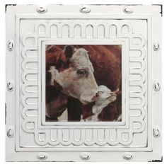 a cow and its baby in a white frame