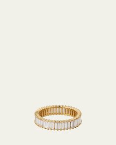 an 18k gold band with baguette cut diamonds, set on a white background