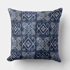 a blue and white pillow with an intricate design