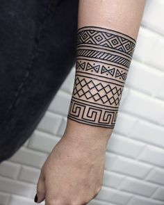 a person with a black and white tattoo on their arm