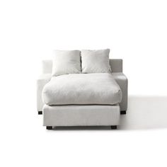 a white couch sitting on top of a white floor