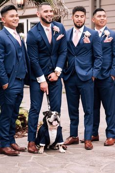 a group of men in suits standing next to each other with a dog on a leash