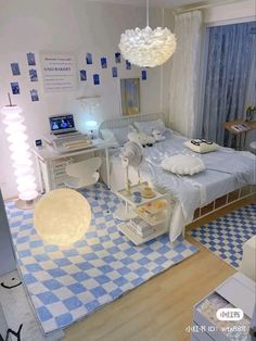 a bedroom with blue and white checkered rugs on the floor next to a bed