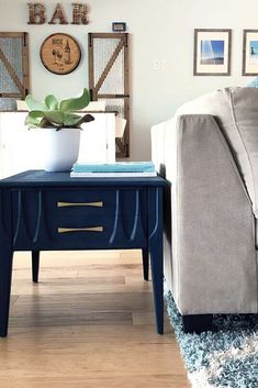 a living room with a couch, coffee table and pictures on the wall